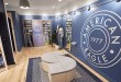 Inside an American Eagle store with a big logo on the wall.