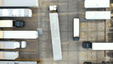 A busy truck yard with terminal tractors and trailers in parking spots Primary focus keyword: yard automation