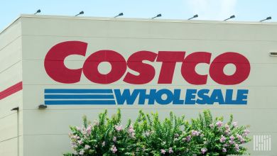 Close up view of a Costco Wholesale logo on the side of a warehouse store.