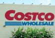 Close up view of a Costco Wholesale logo on the side of a warehouse store.