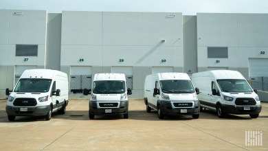 delivery vans in front of dock doors at a warehouse