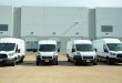 delivery vans in front of dock doors at a warehouse