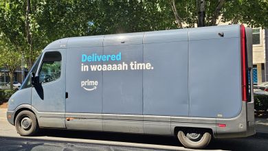 Side view of an Amazon delivery van on a city street.