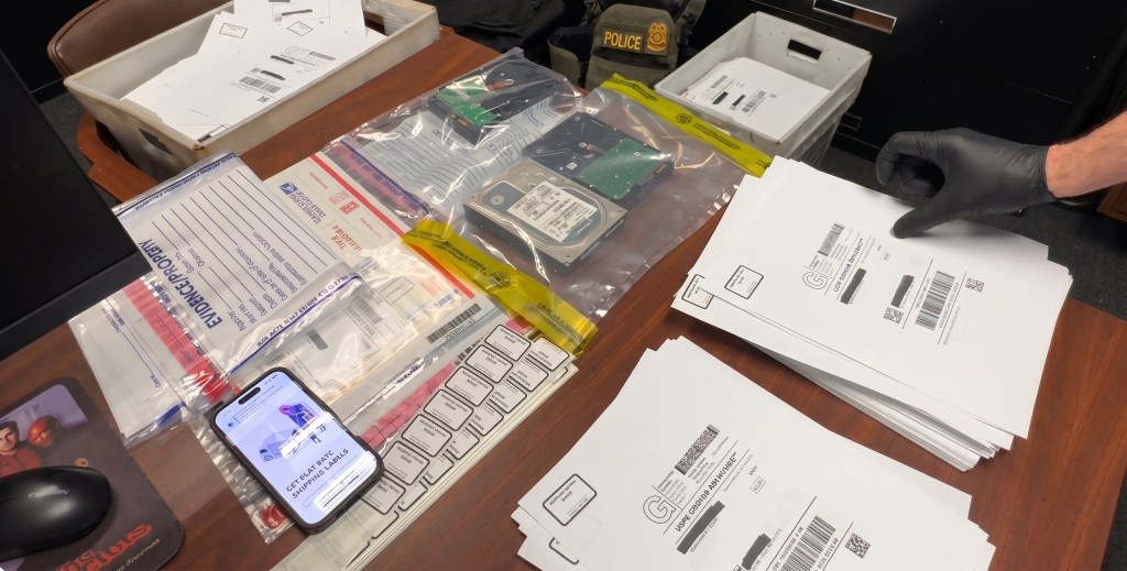 Hand of a police officer in a rubber glove is seen laying out evidence on a table.