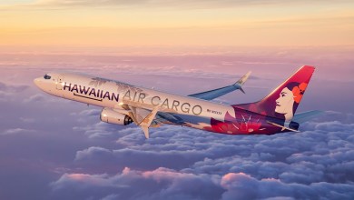 Image of a Hawaiian Air Cargo jet flying above the clouds.