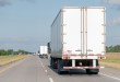 White dry van trailer on a highway as U.S. Bank and DAT data show contract rates ending August 22 cents above spot