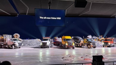 Five Volvo VNX trucks, including a log hauler, dump trucks and a concrete mixer, lined up at the VNX reveal