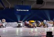 Five Volvo VNX trucks, including a log hauler, dump trucks and a concrete mixer, lined up at the VNX reveal