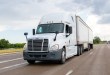 a white daycab pulling two LTL pup trailers