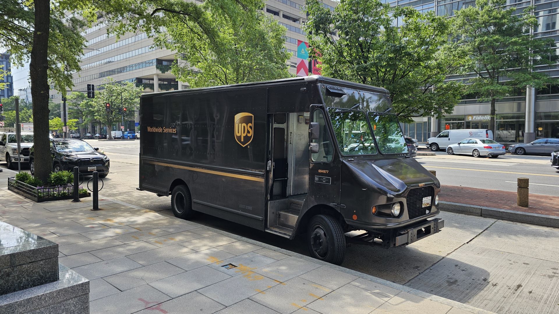 A UPS package car is parked in Washington, D.C., while the driver delivers packages to an office building. Unionized drivers will be seeking a new contract, with even stronger benefits, in 2028. (Photo: Eric Kulisch/FreightWaves)