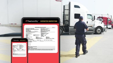 Tablet and phone show a Fleetworthy Expedited Inspection report as an enforcement officer walks toward a semitruck