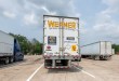 a rearview of a Werner trailer parked at a truckstop