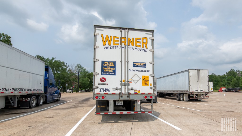 a rearview of a Werner trailer parked at a truckstop
