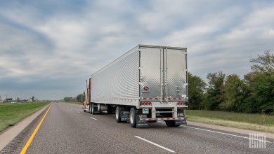 A tractor trailer driving down the highway