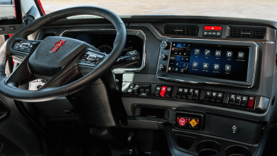 Kenworth truck dashboard with the PACCAR Connect touchscreen showing apps for vehicle health, camera and operator manuals