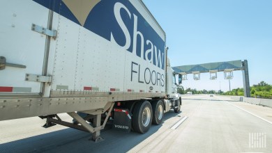 Shaw Industries private-fleet tractor-trailer on a highway, part of the company’s distribution network used for outbound deliveries and reverse logistics of EcoWorx carpet tile.