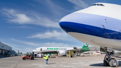 An EVA cargo jet in the background and the front nose of a China Airlines Cargo 747 are seen in this photo at an airport.
