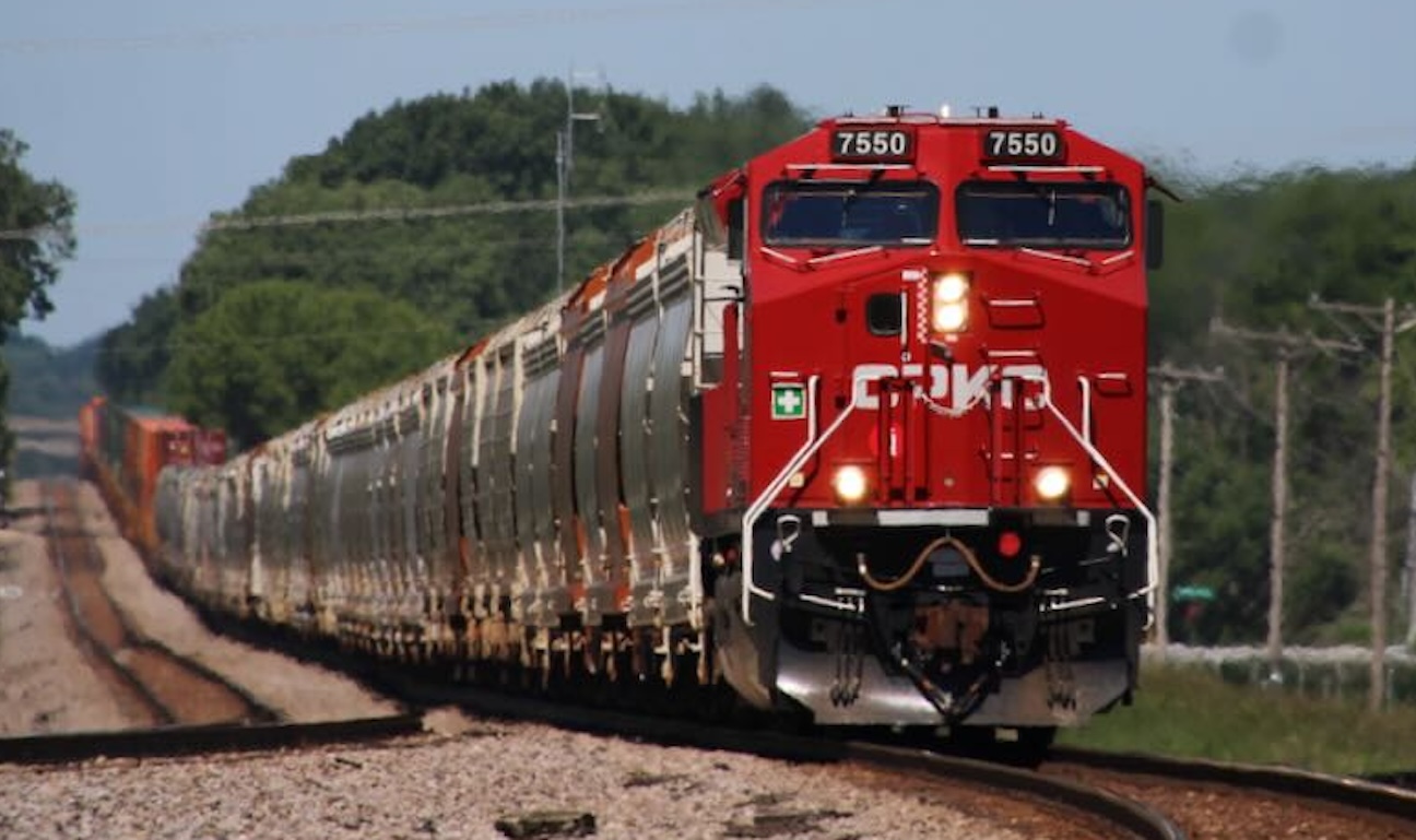 Recently delivered CPKC ET44AC No. 7550 leads a consist of frac sand hoppers, grain hoppers, and intermodal well cars at Brookfield, Wis., on June 12, 2026. (Photo: Trains/David Lassen)